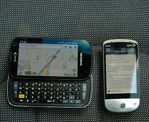 Two handsets on the seat of a car. Shhh... I promise I just look when stopped at lights. Anyway, one has the meeting pulled up, the other is navigating.